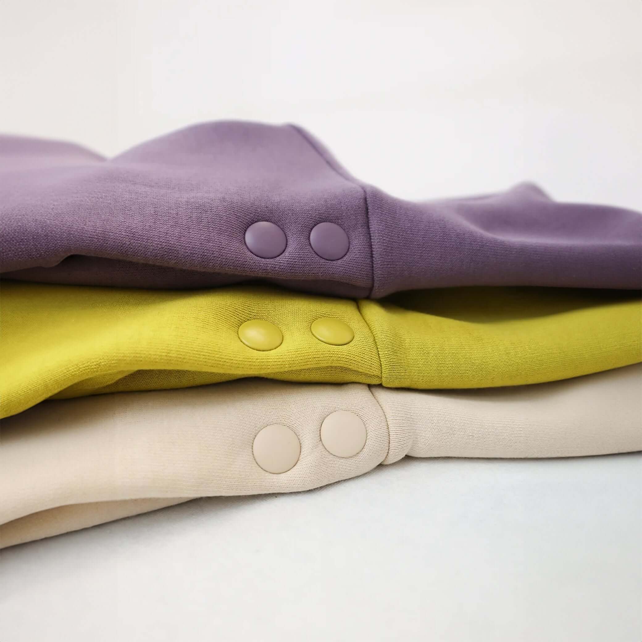 Dress with elastic waistband and hood with snap buttons